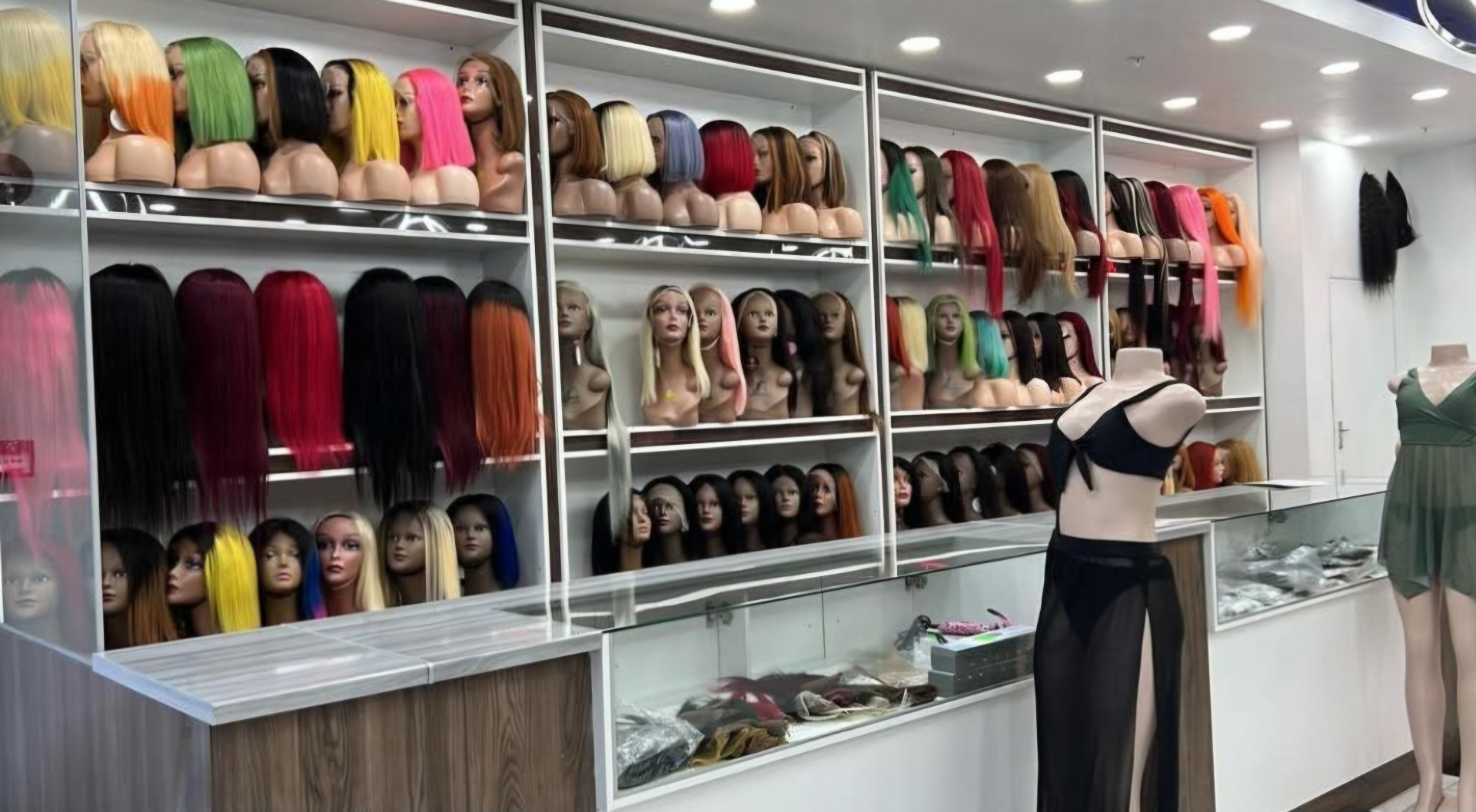 Inside Elegant Head Lover's Salon showing the wall of wigs