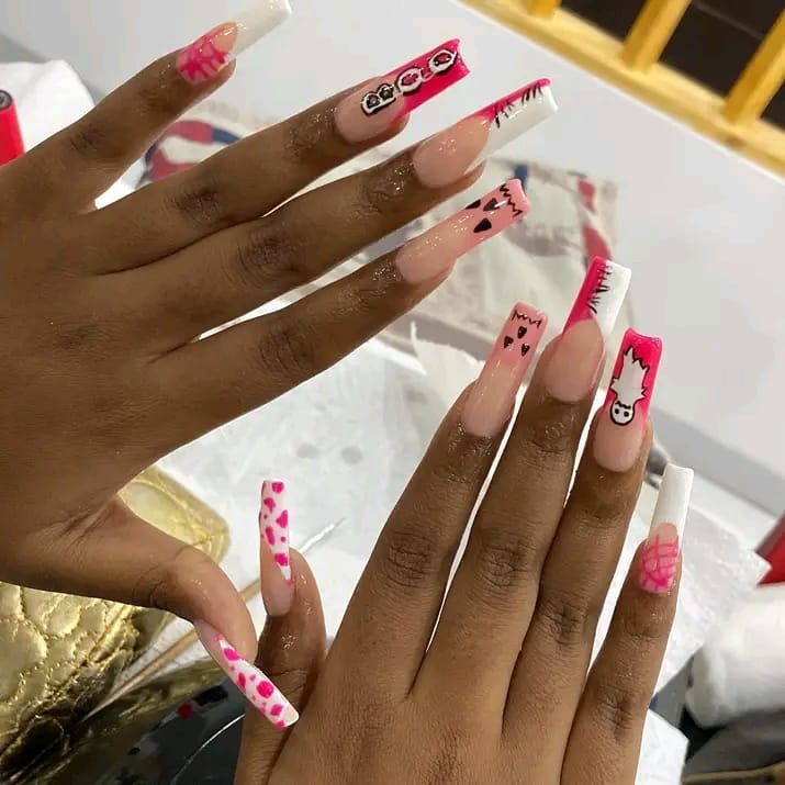 Long coffin nails with pink and white freehand nail art